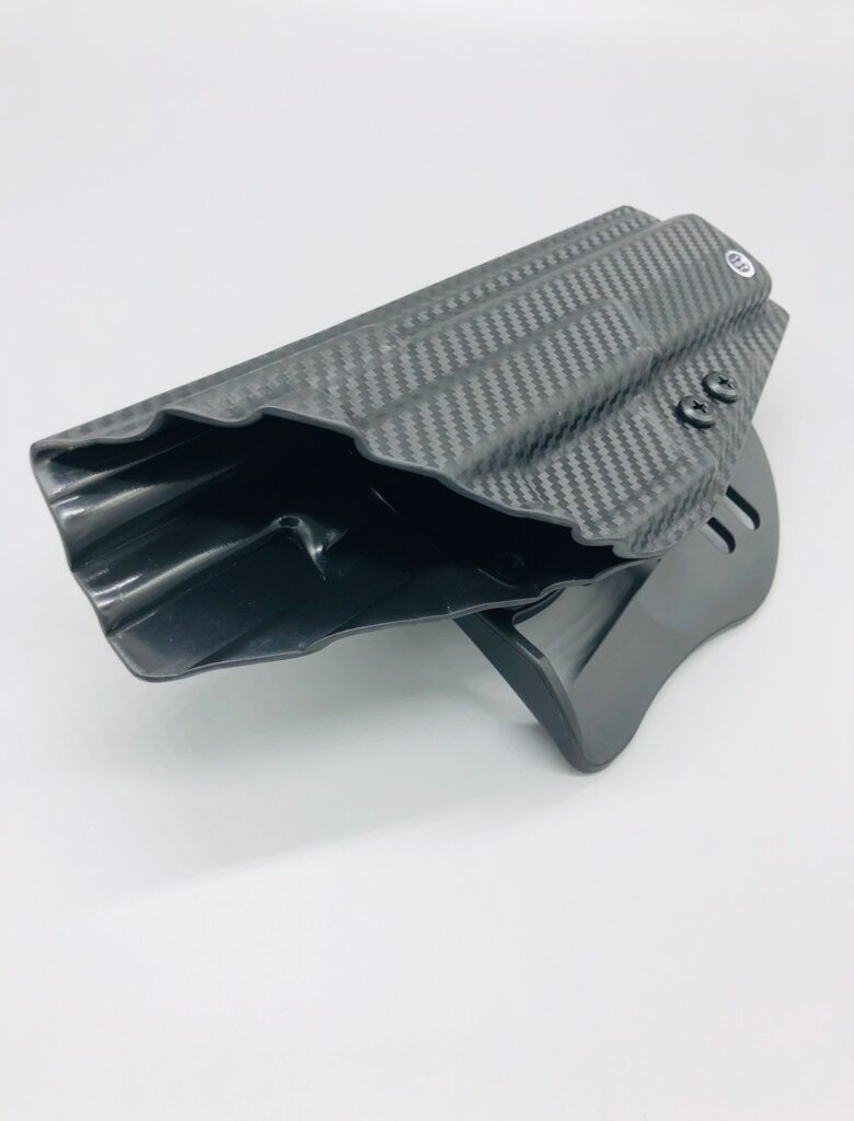 Black carbon fiber Kydex OWB paddle holster viewed from the muzzle end