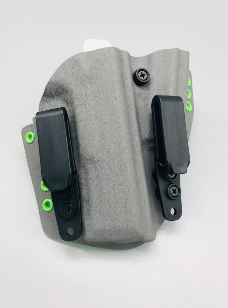 Grey Hades Series Kydex sidecar holster with two belt clips and green hardware