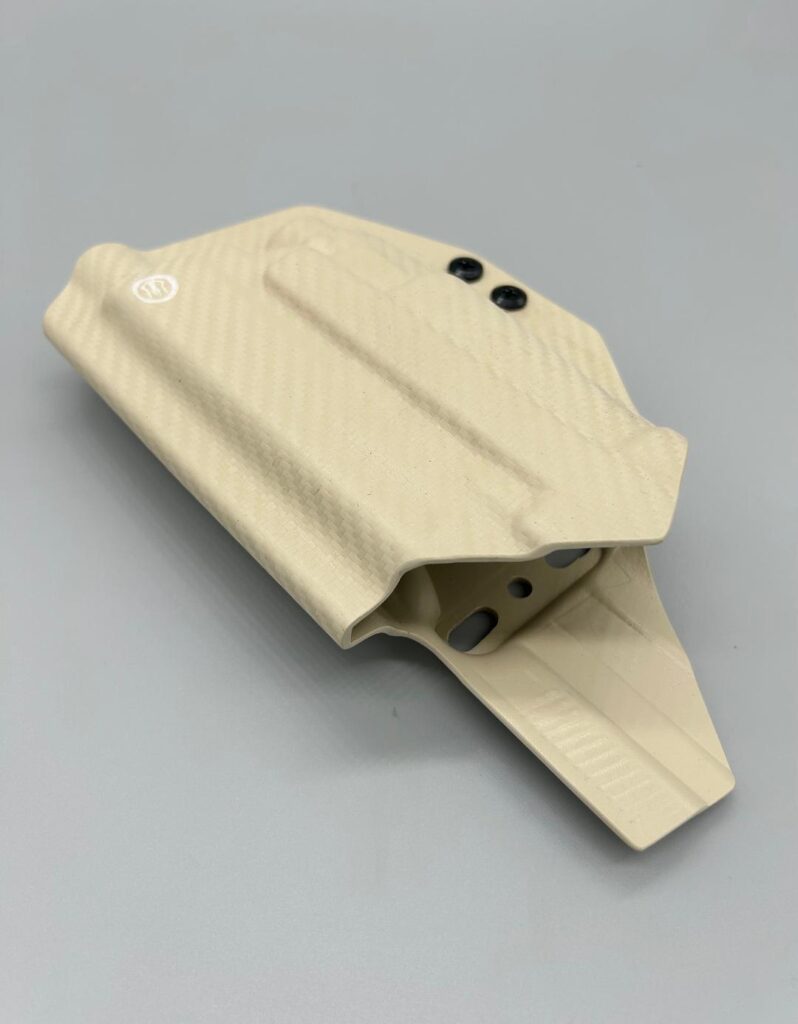 Sand carbon fiber Kydex Veritas Series OWB holster seen from the muzzle end, belt loop folded beneath