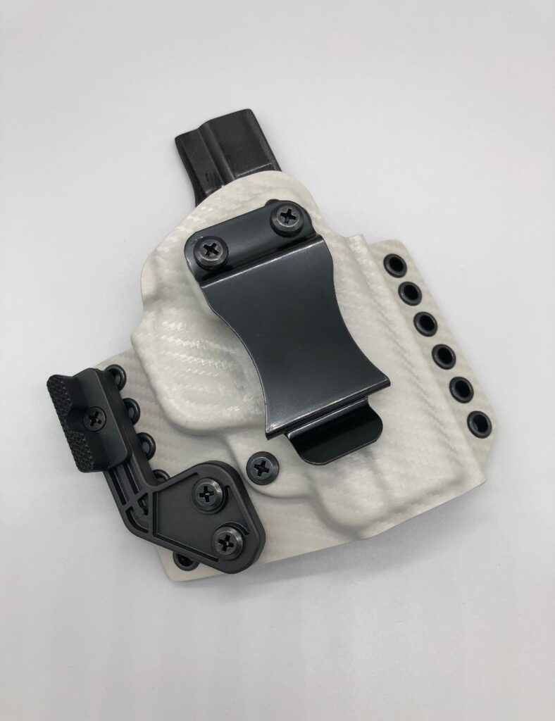 White and grey Theseus 2.0 Kydex holster with an attached magazine carrier