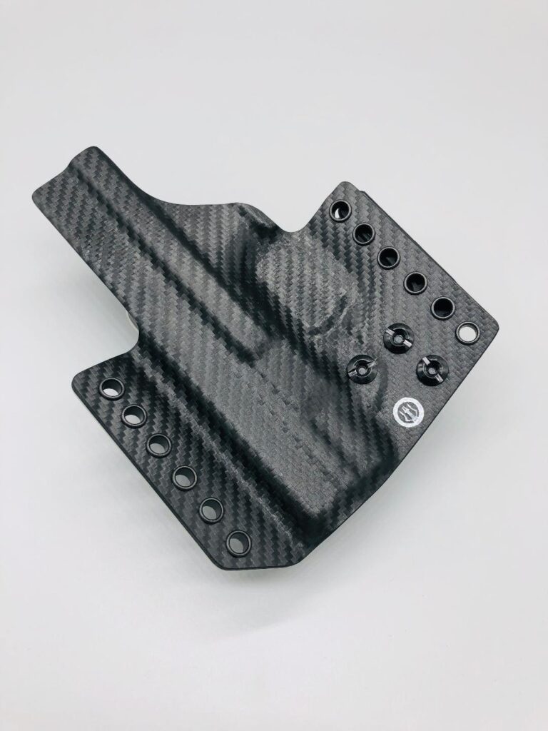 Black carbon fiber Theseus 2.0 Kydex holster shell laid flat, showing its molded outline