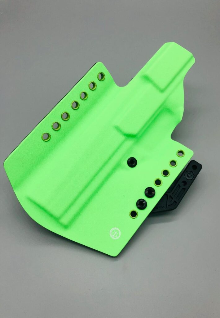 Neon green Kydex holster shell showing the molded outline and eyelets