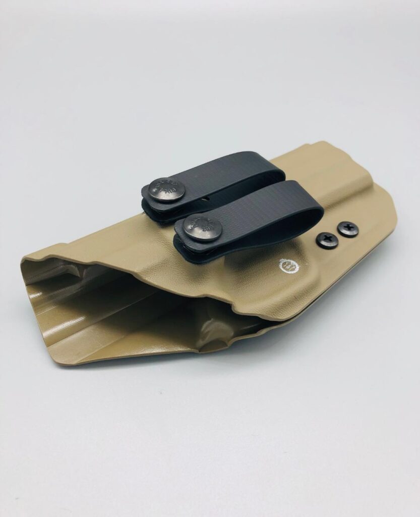 Tan Kydex holster shell shown open at the mouth with twin belt clips