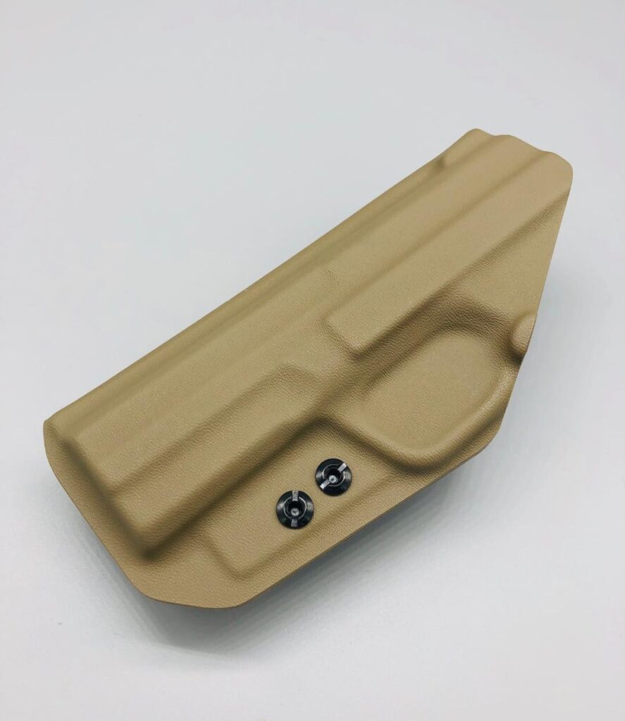 Tan Kydex holster shell laid flat, showing the molded light channel